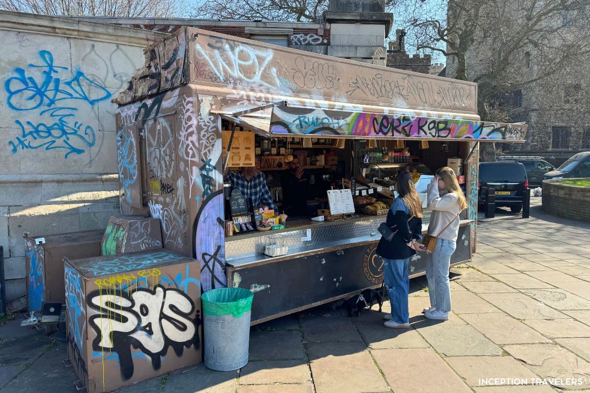 Graffiti-covered coffee kiosk of 2 Love Coffee House with customers ordering at the counter