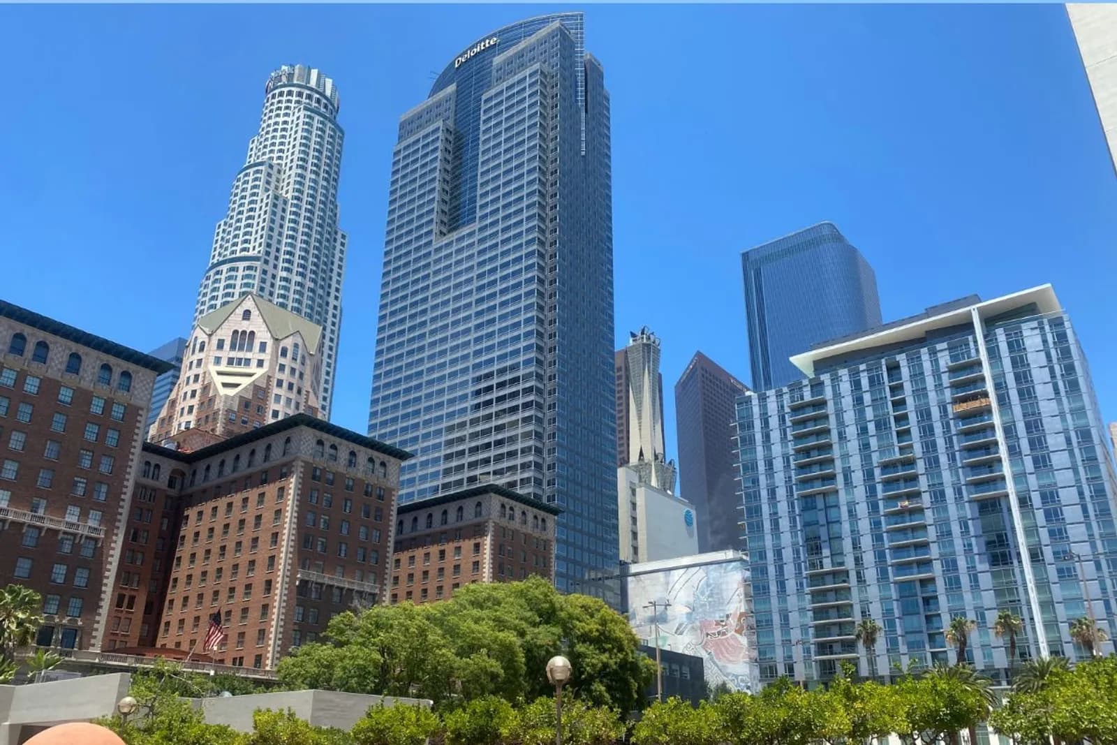 US Bank Tower and glass skyscrapers rising behind the brick Biltmore Hotel in downtown Los Angeles